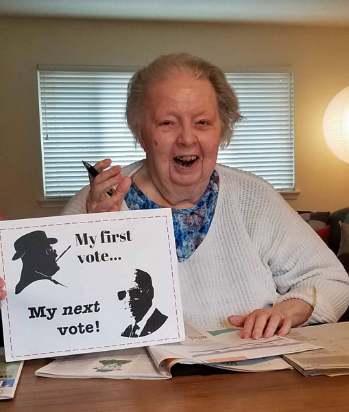 happy elderly woman votes
